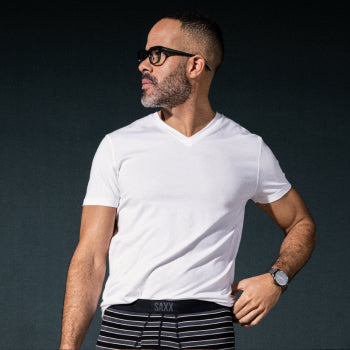 Man in white shirt and boxer briefs wearing glasses and watch