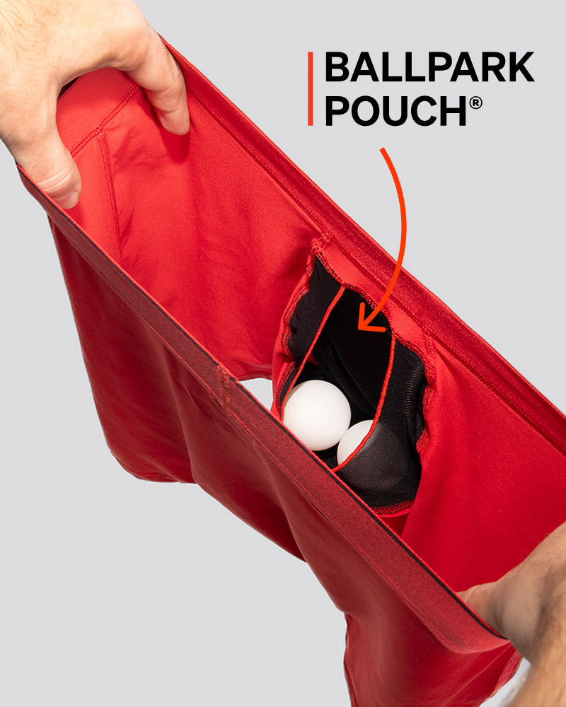 A pair of red boxer briefs being held open to reveal an internal pouch.