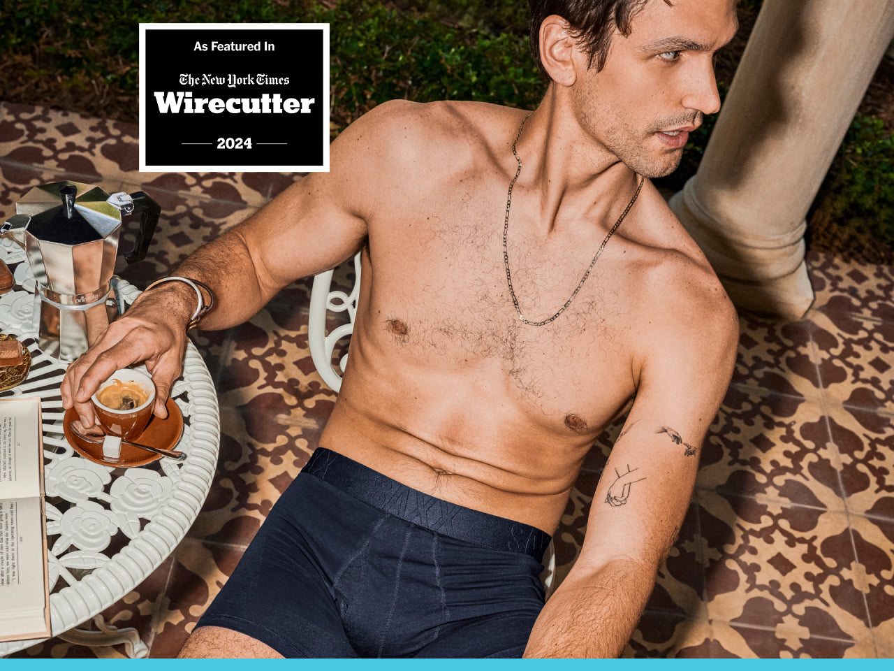 A man seen from above drinking an espresso. He is wearing navy color boxer briefs only.