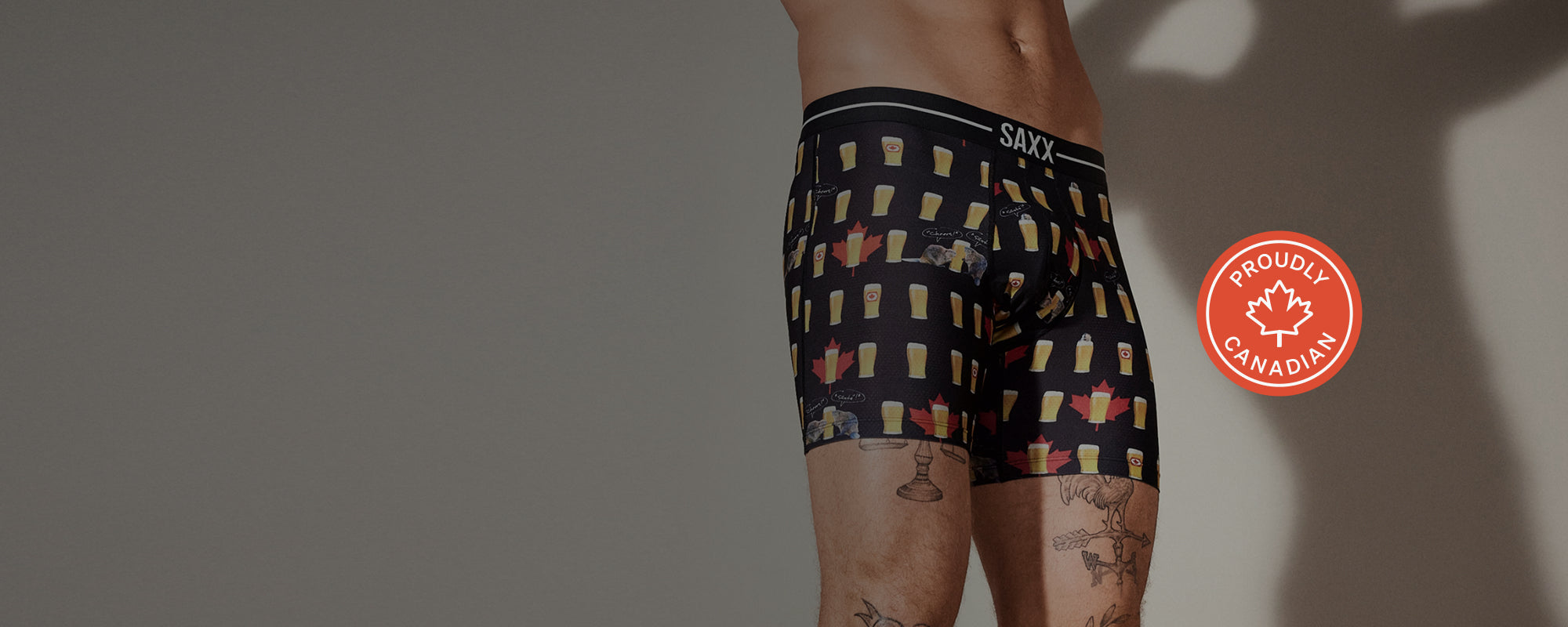 Maple leaf patterned boxer briefs with 'SAXX' branding on a gray background
