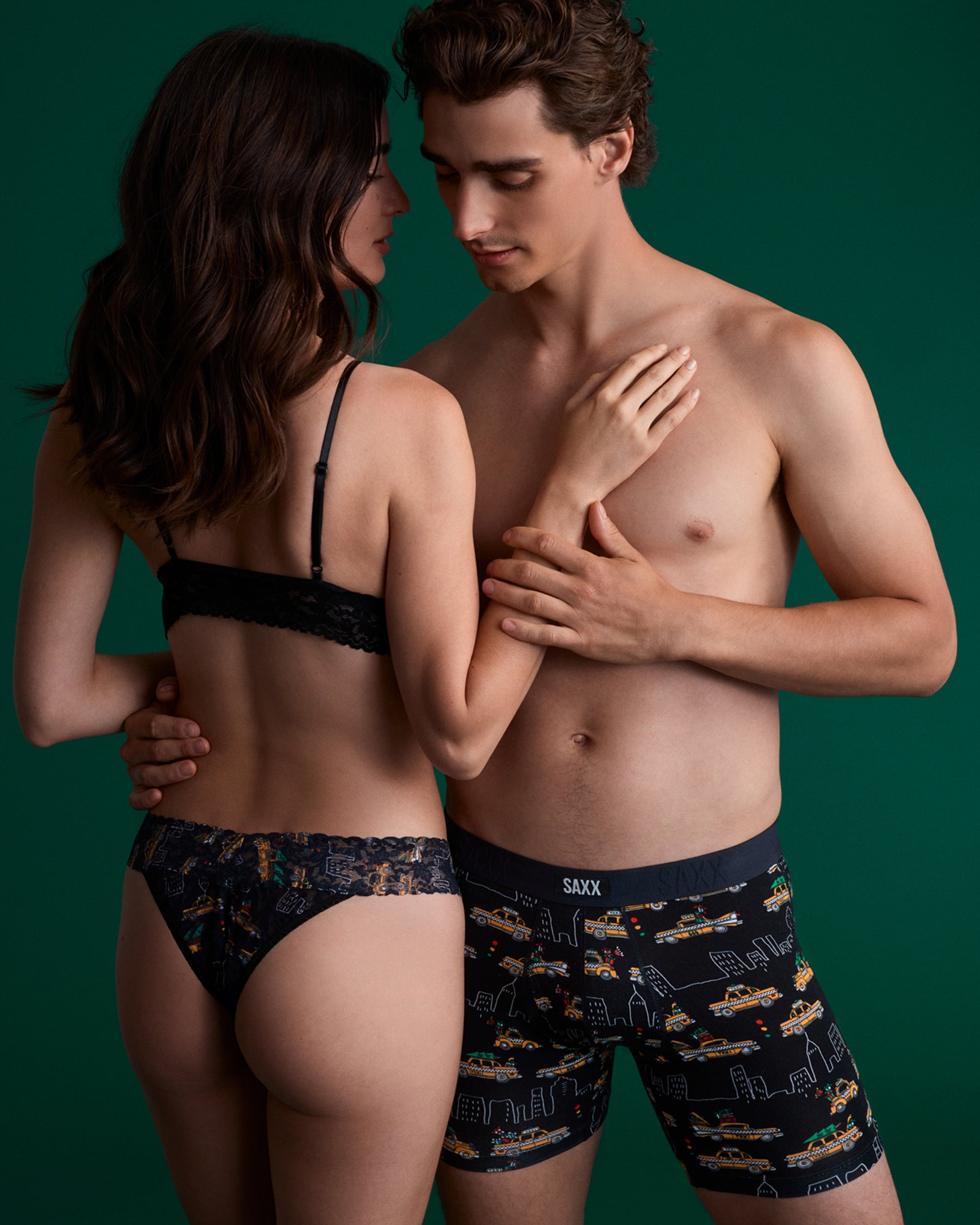 Man and woman wearing patterned underwear against a green background