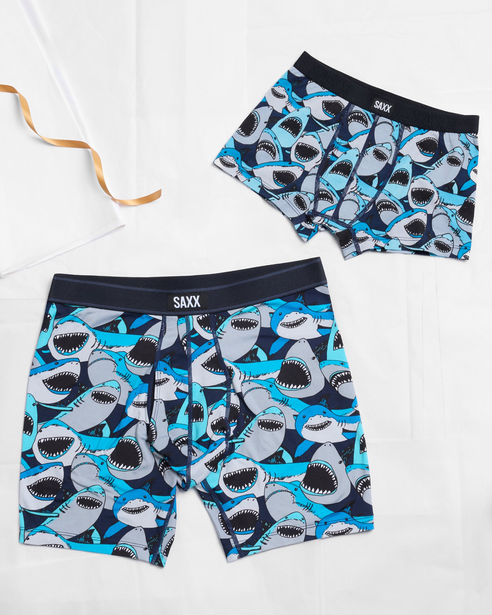 Shark-patterned boxer briefs with SAXX branding on a white background