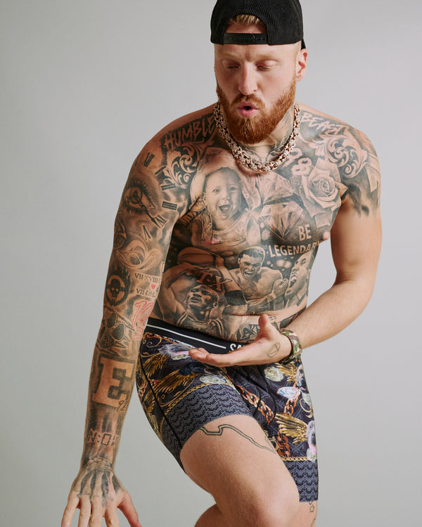 Maxx Crosby posing in his limited edition SAXX Underwear print, Volt Breathable Mesh Boxer Brief in Dogs Of Maxx-Black