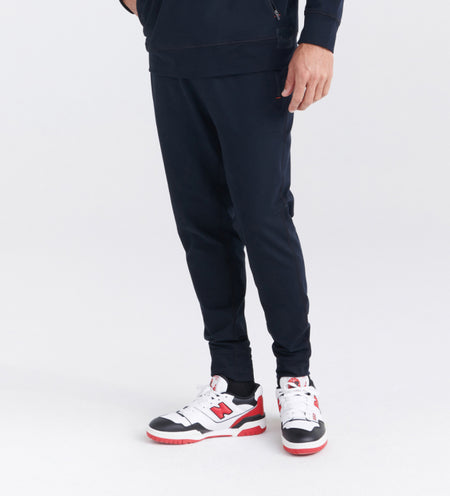 Man wearing black sweatpants and white sneakers