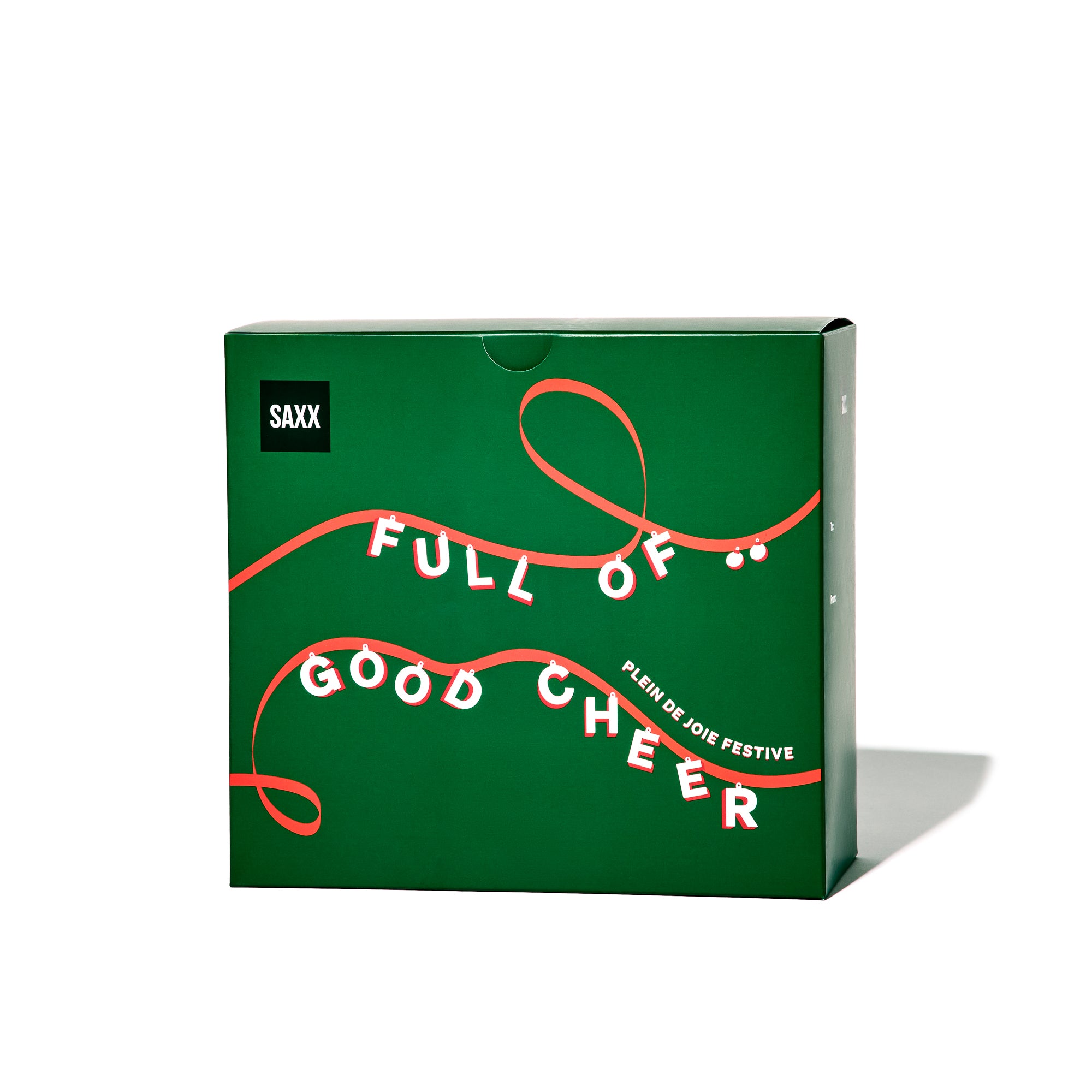 Green box with red text and ribbon design, featuring the brand 'SAXX'.