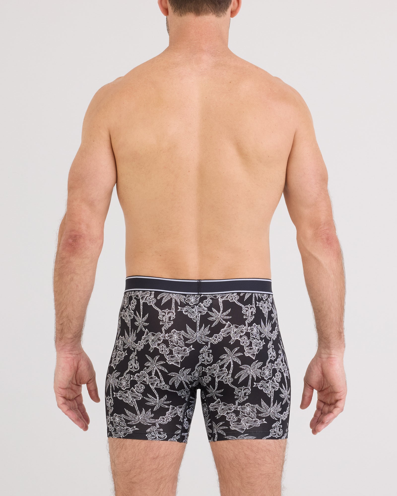 Back - Model wearing Daytripper Comfort Stretch Boxer Brief Fly in Tropical Tattoo-Black