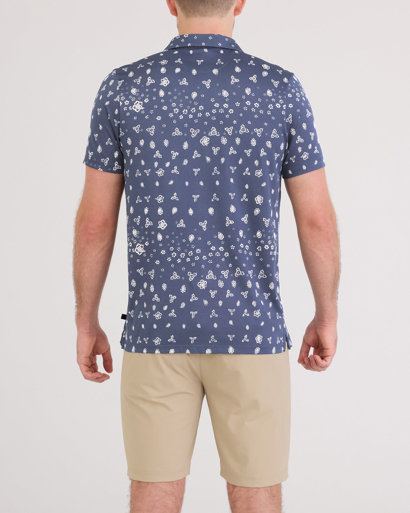 Back - Model wearing Droptemp Dry Resort Polo in Bandana Tropic-Indigo