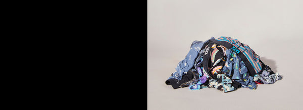 Pile of underwear in different colors and patterns on grey backdrop