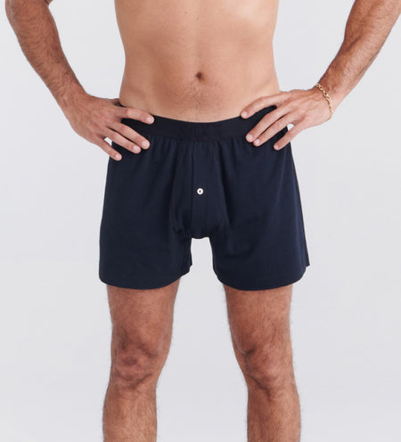 man wearing black loose fit sleep boxers