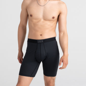 Shirtless man standing in black long leg boxer briefs