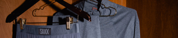 Gray underwear and apparel hanging in a wooden closet