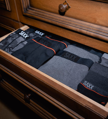 Several pairs of underwear in a wooden drawer
