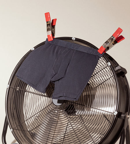 A pair of black Boxer Briefs draped over a fan