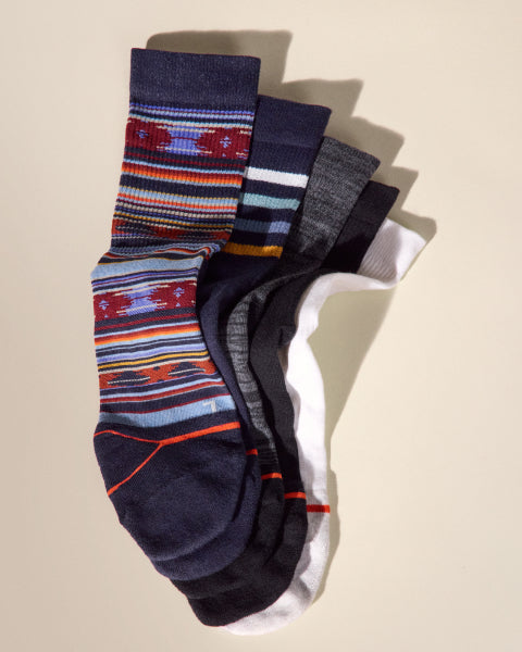 Set of colorful patterned socks on a beige background