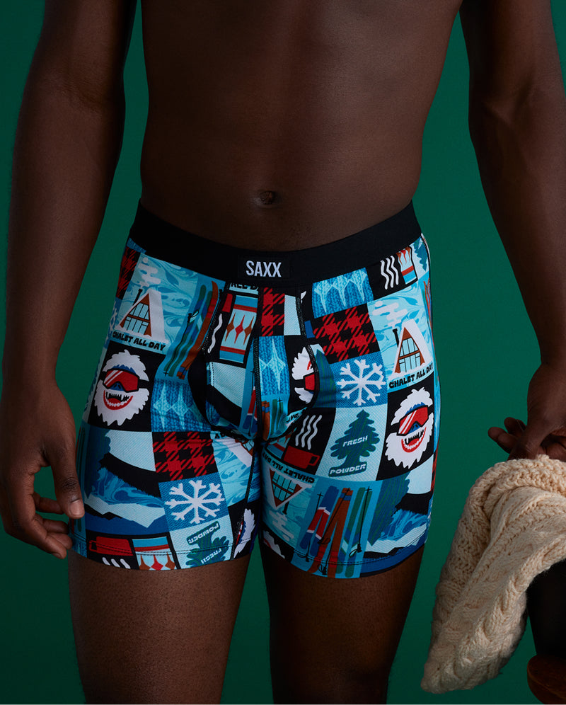 A person holding a knit sweat wearing SAXX Boxer Briefs