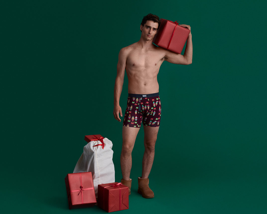 Man wearing patterned underwear with red gifts on a green background