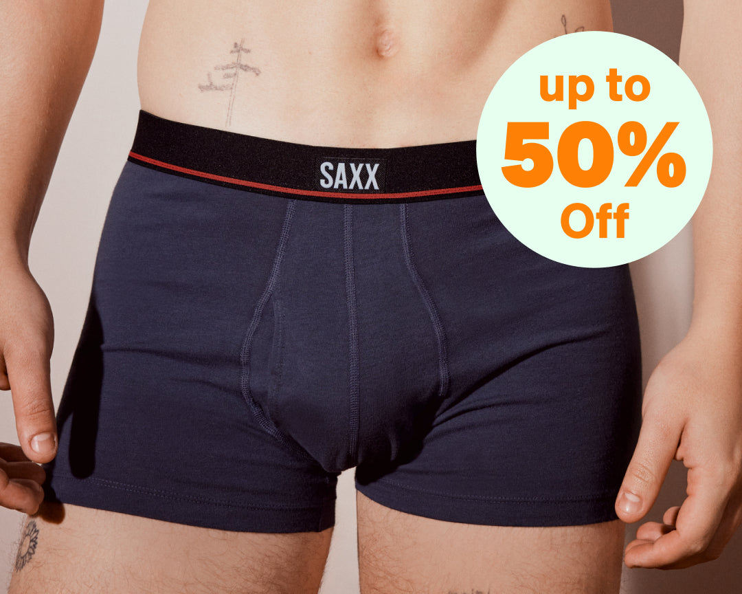 A split screen of two images. On the left is a close up of a man wearing boxer briefs. On the right three pairs of blue boxer briefs.