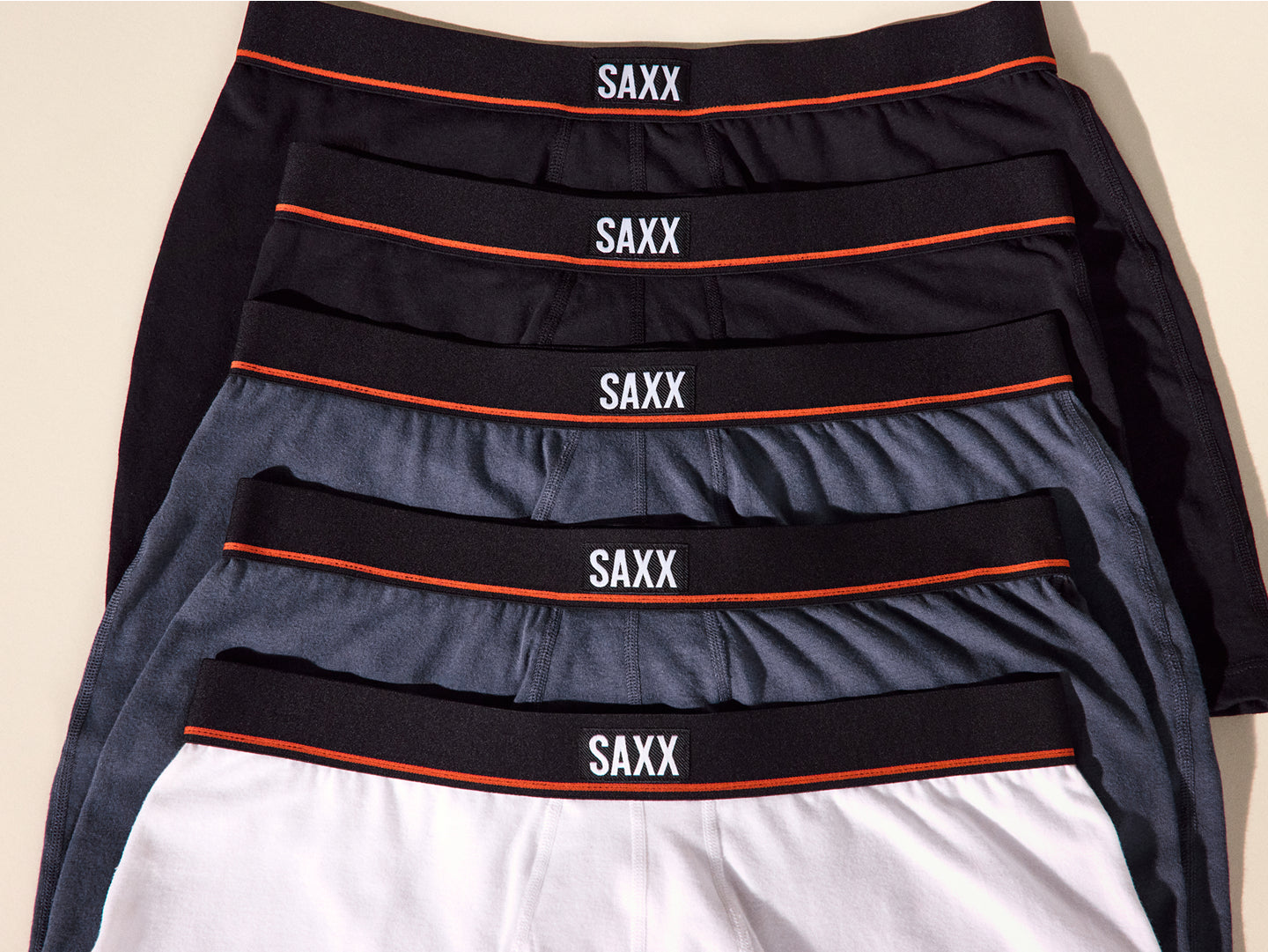 Set of SAXX underwear in black, gray, and white with visible branding.
