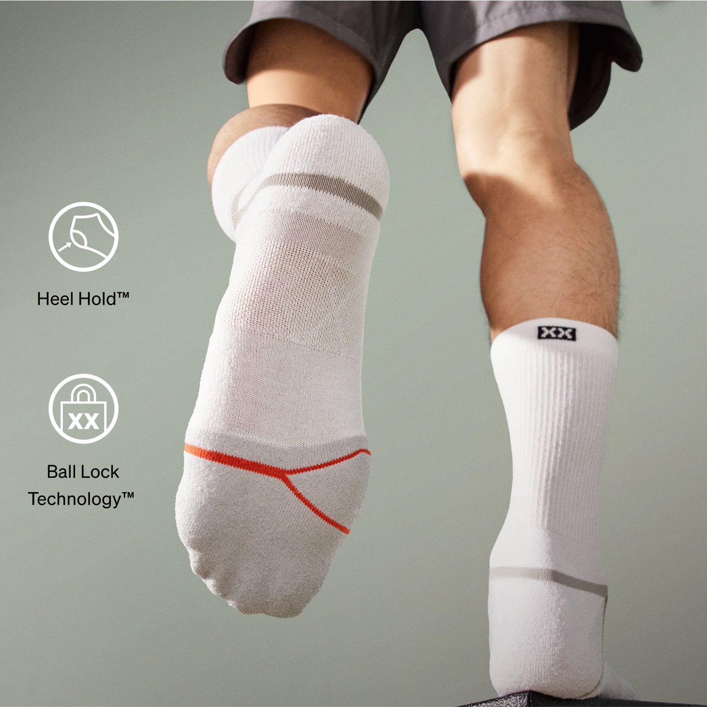 White socks with heel hold and ball lock technology on a gray background