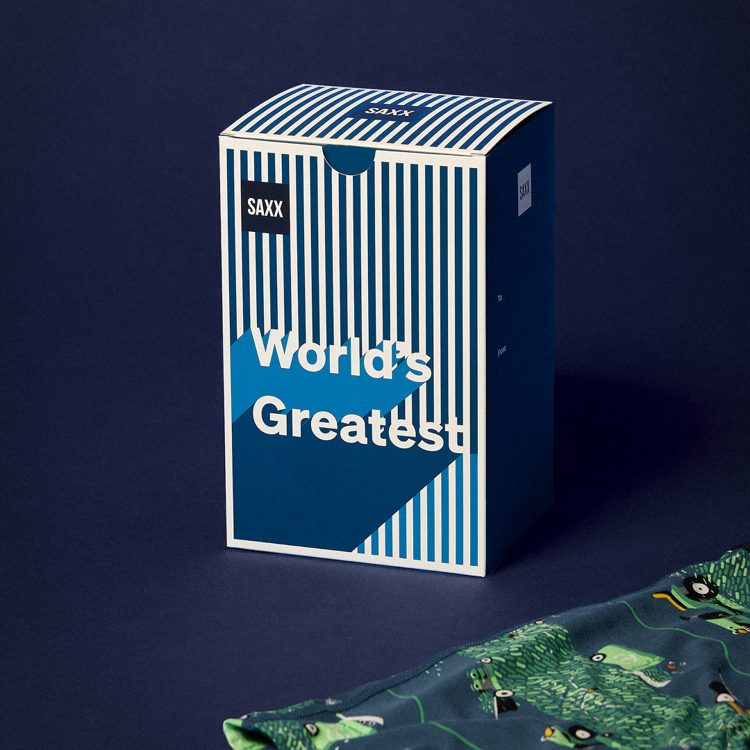 A split screen image of a pair of printed boxer briefs on the left and a gift box on a blue background to the right. 