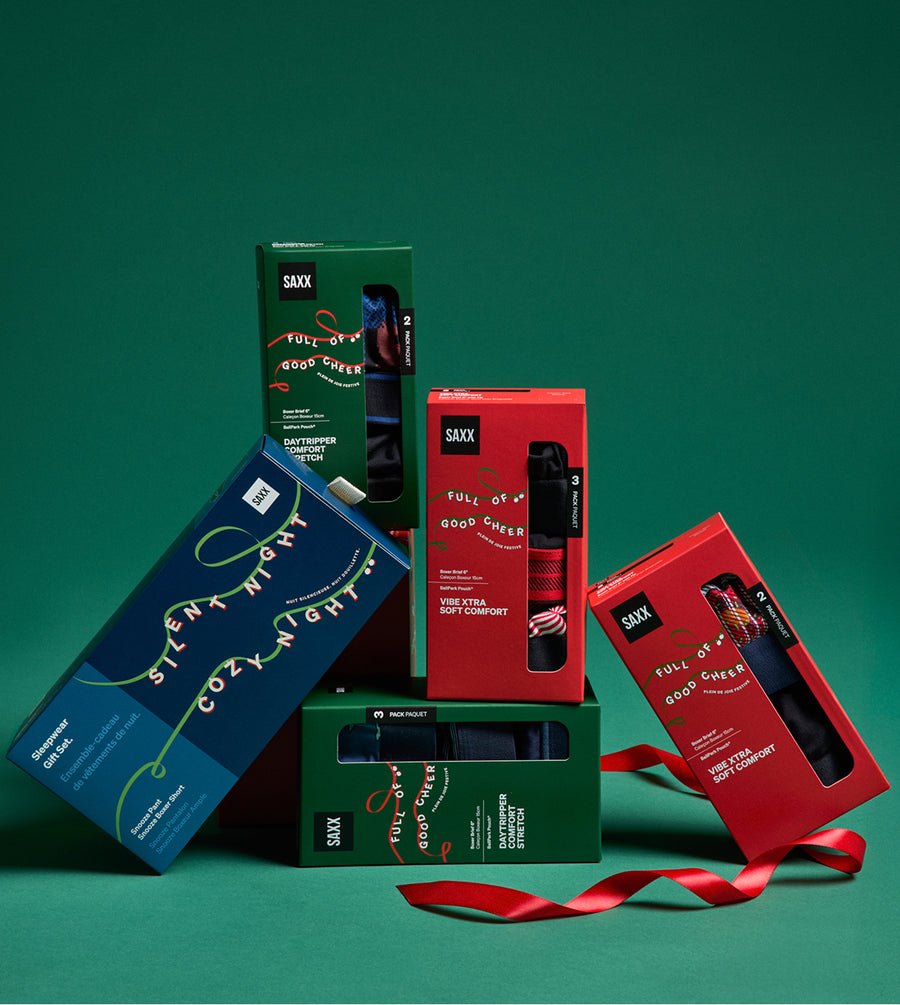 Neat pile of limited edition holiday gift boxes and red ribbon