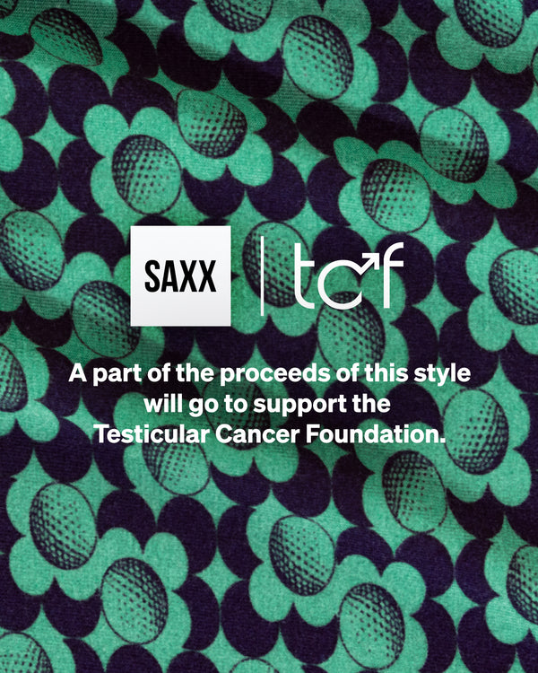 A close up image of a green and blue floral print on stretch knit fabric.
