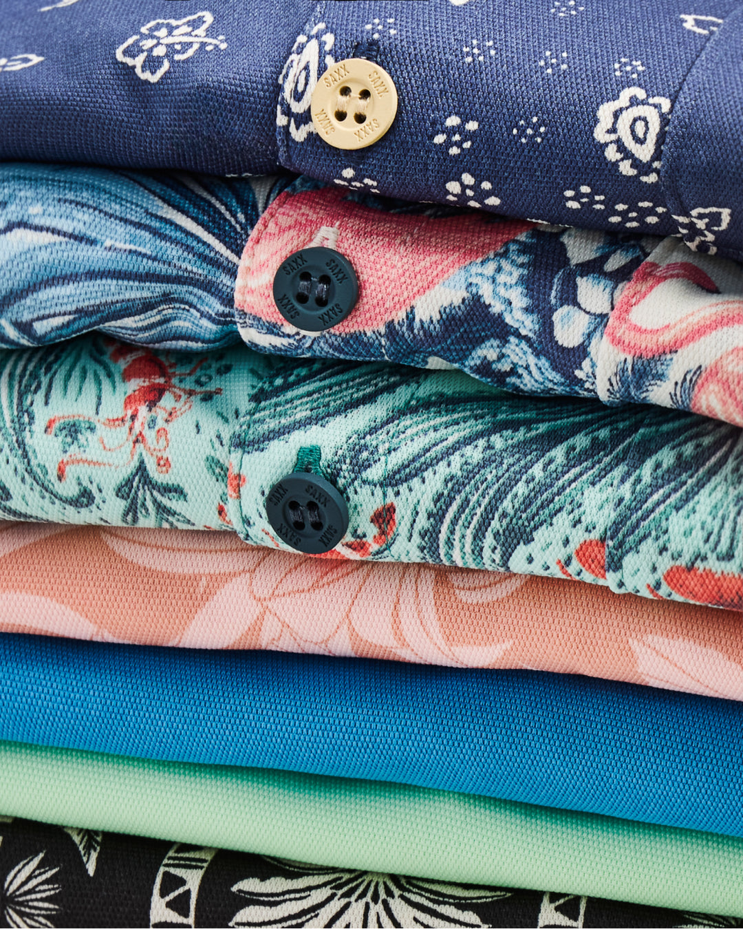 Stack of folded fabric with various patterns and colors