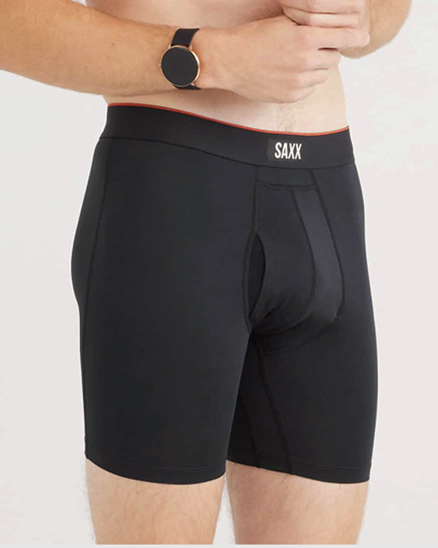 Model wearing black boxer briefs with 'SAXX' branding on a plain background