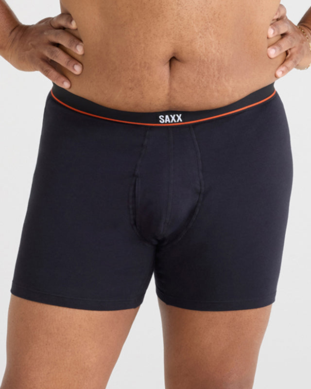 Model wearing black boxer briefs with 'SAXX' branding on a plain background