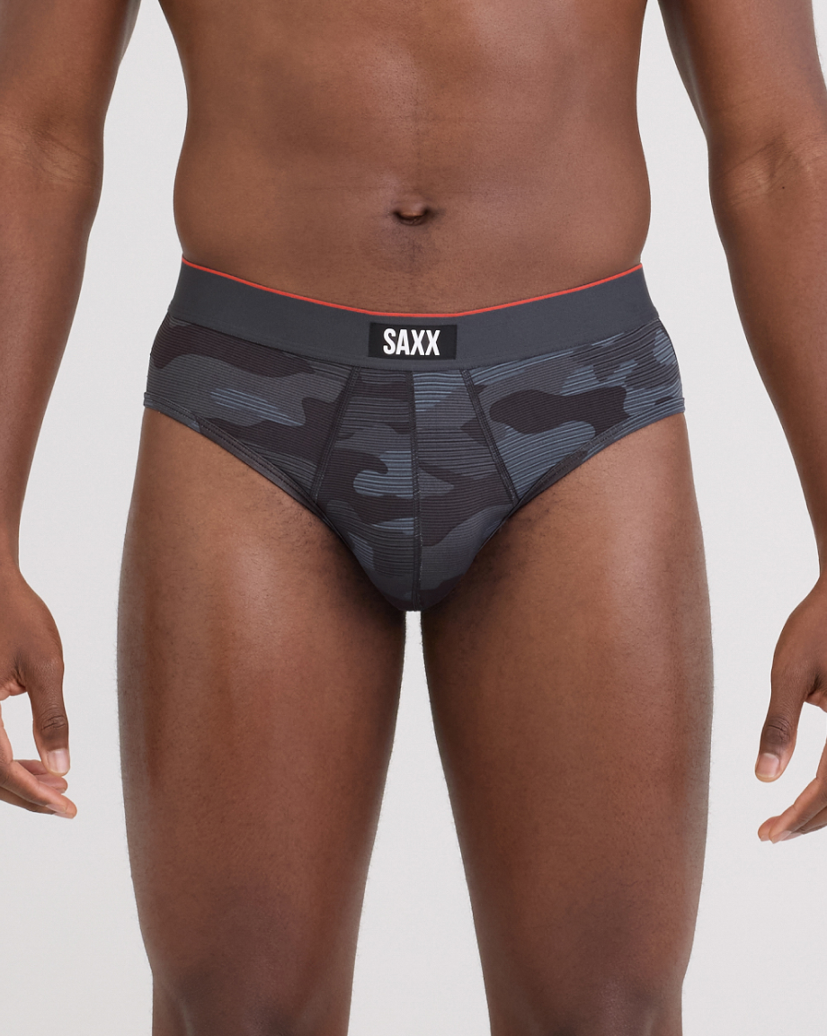 Black camo-patterned underwear with SAXX branding on a neutral background