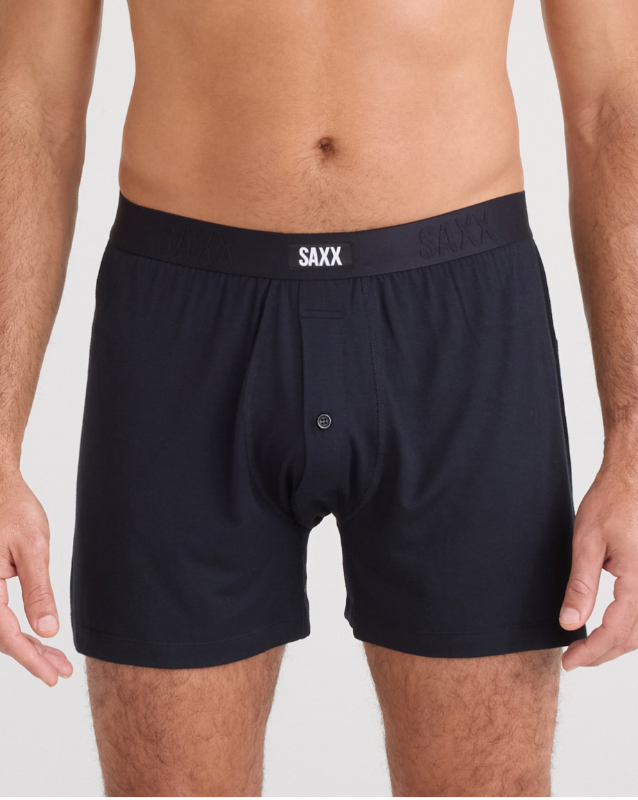Black boxer briefs with SAXX branding on a plain background