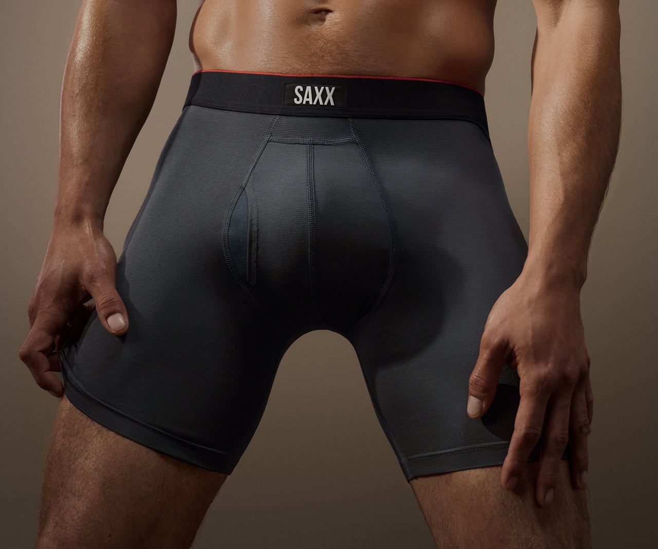 Person wearing black SAXX underwear against a neutral background