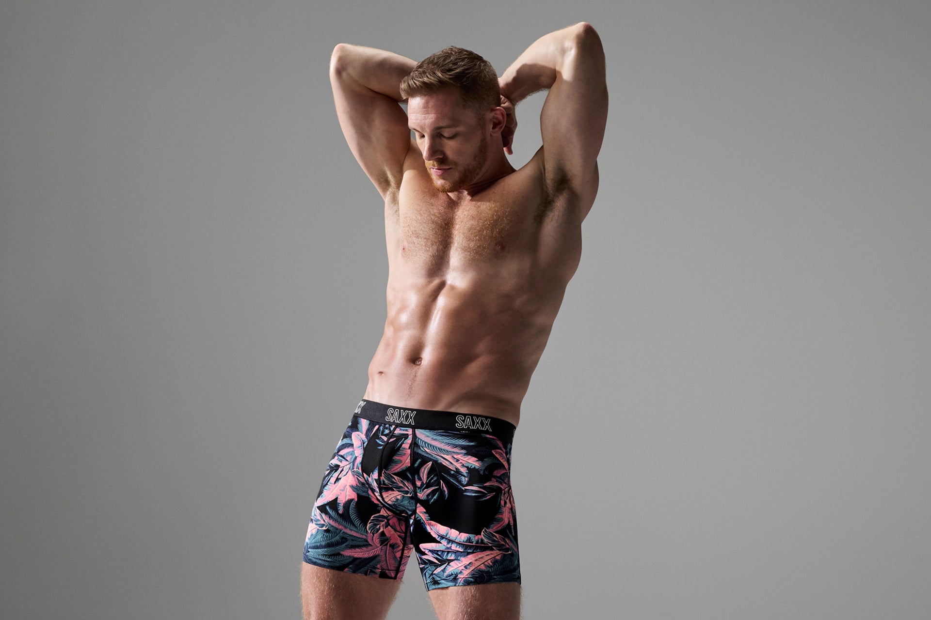 Man posing in SAXX Free pouchless Boxer Briefs
