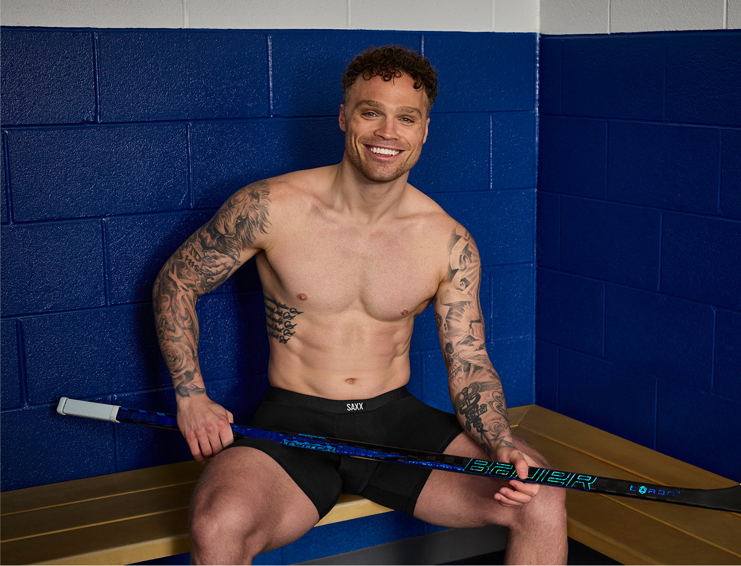 SAXX Gamechanger and Professional Hockey Player Max Domi poses in Vibe Xtra boxer brief in black.