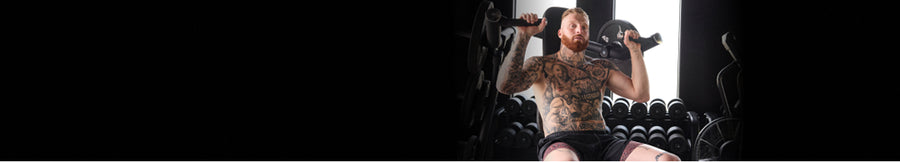 Pro Football Player Maxx Crosby posing in SAXX performance apparel in a gym.