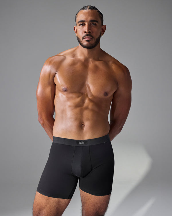 Model poses in SAXX Free 24Seven Cotton Boxer Brief in Black