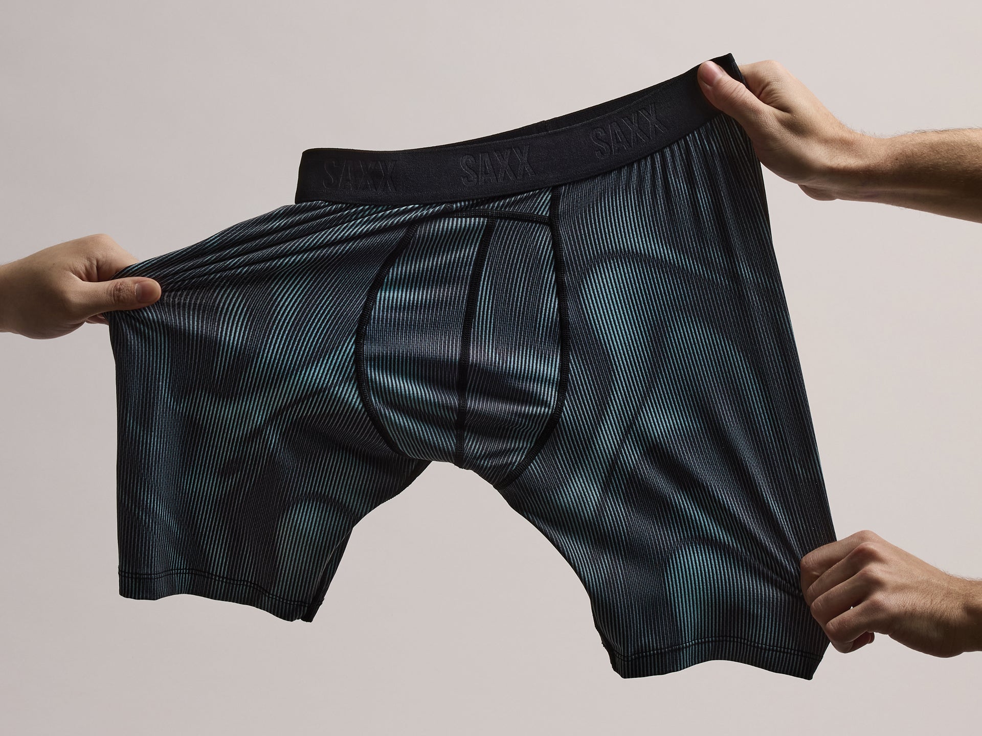 Saxx Underwear Smooth Flex Boxer Brief getting stretch by hands in multiple directions