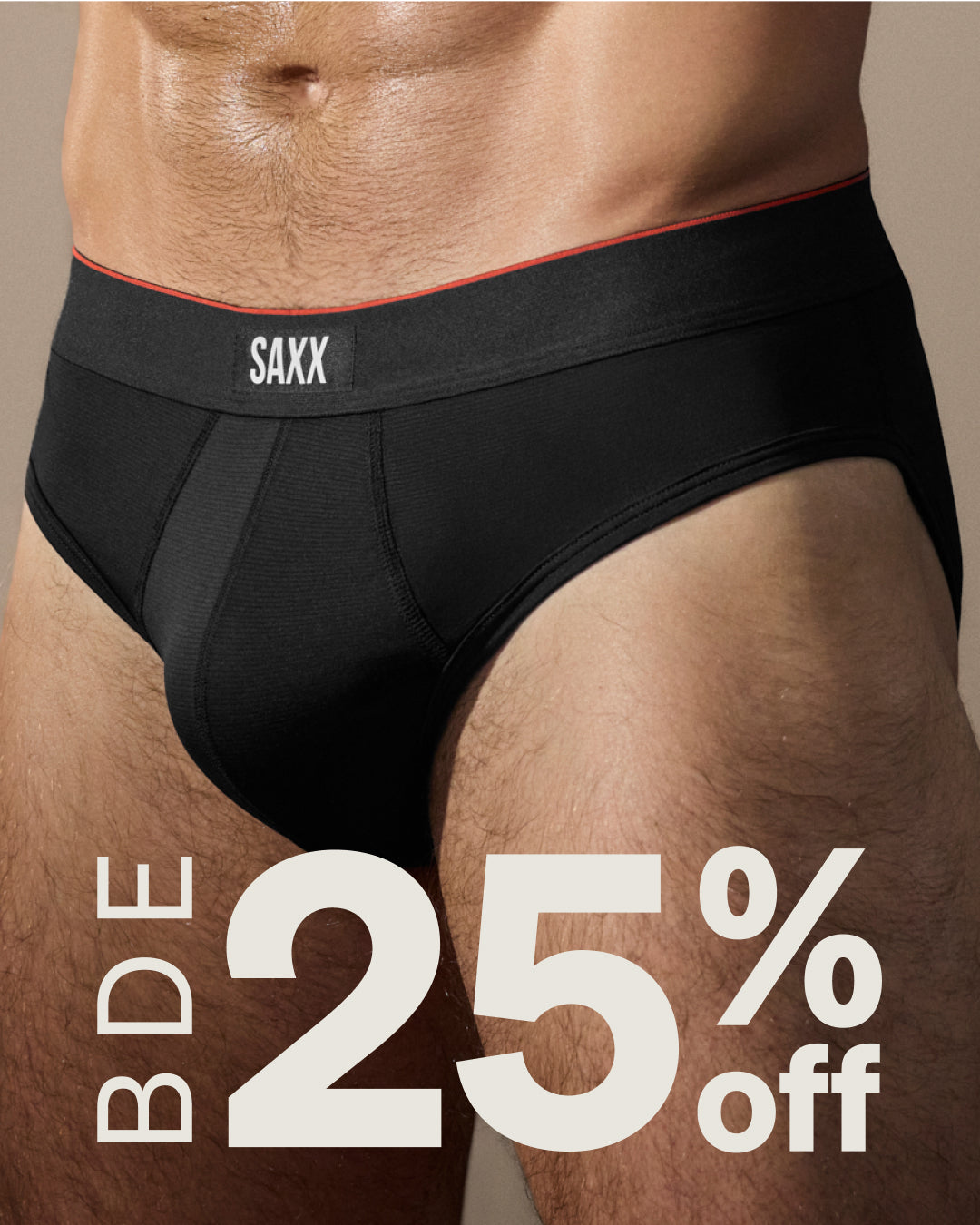 Black men's underwear with 'SAXX' brand on a beige background, featuring a 25% off discount offer.