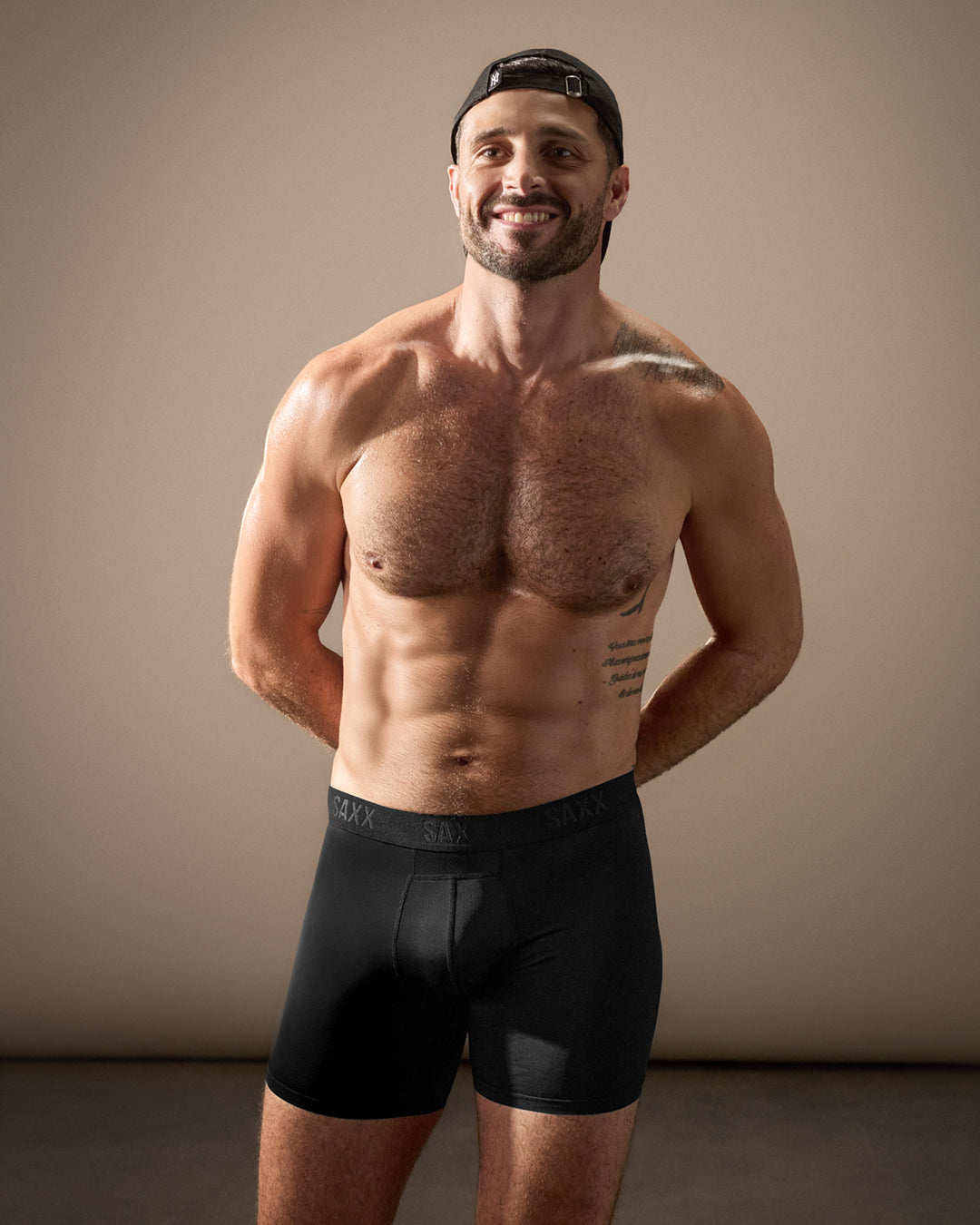Male model wearing black SAXX underwear smiling showing supportive fit confidence and everyday comfort