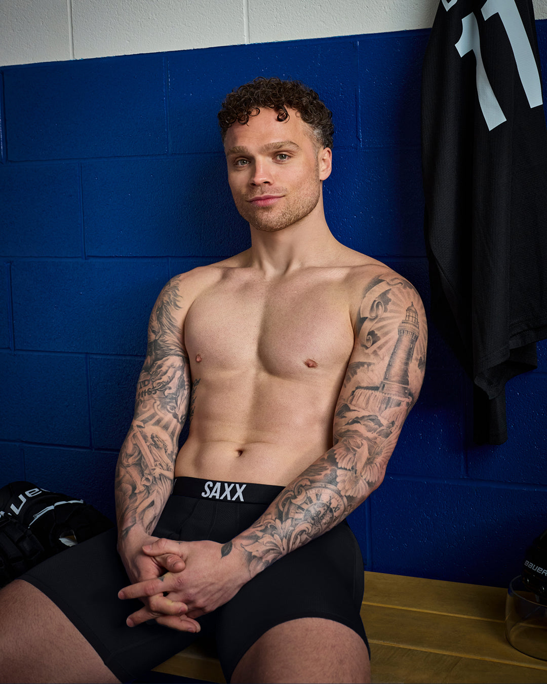 SAXX Gamechanger and Professional Hockey Player Max Domi, sitting shirtless in a locker room wearing SAXX underwear.