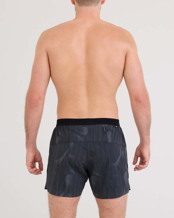 Back - Model wearing Race Pace 2N1 Run Short 5" in Smoke Camo-Dark Charcoal
