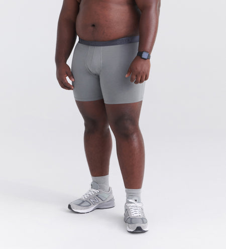 Man wearing gray silk boxer briefs and runners