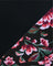 Floral patterned fabric with pink and green flowers on a black background