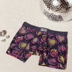 Disco balls surrounding purple boxer briefs in a fruit print