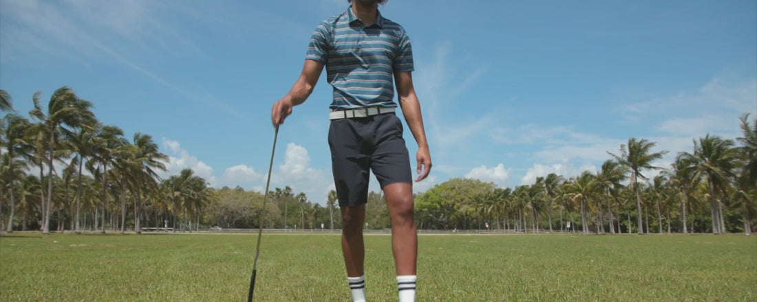 A video of men wearing shorts and polo shirts on a golf course. They are seen in different golf poses with golf clubs.
