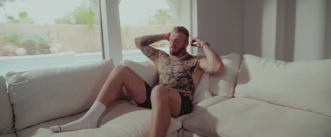 Maxx Crosby lounges on a couch in SAXX Underwear