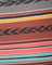 Close-up of a fabric with colorful stripes and a brand name.