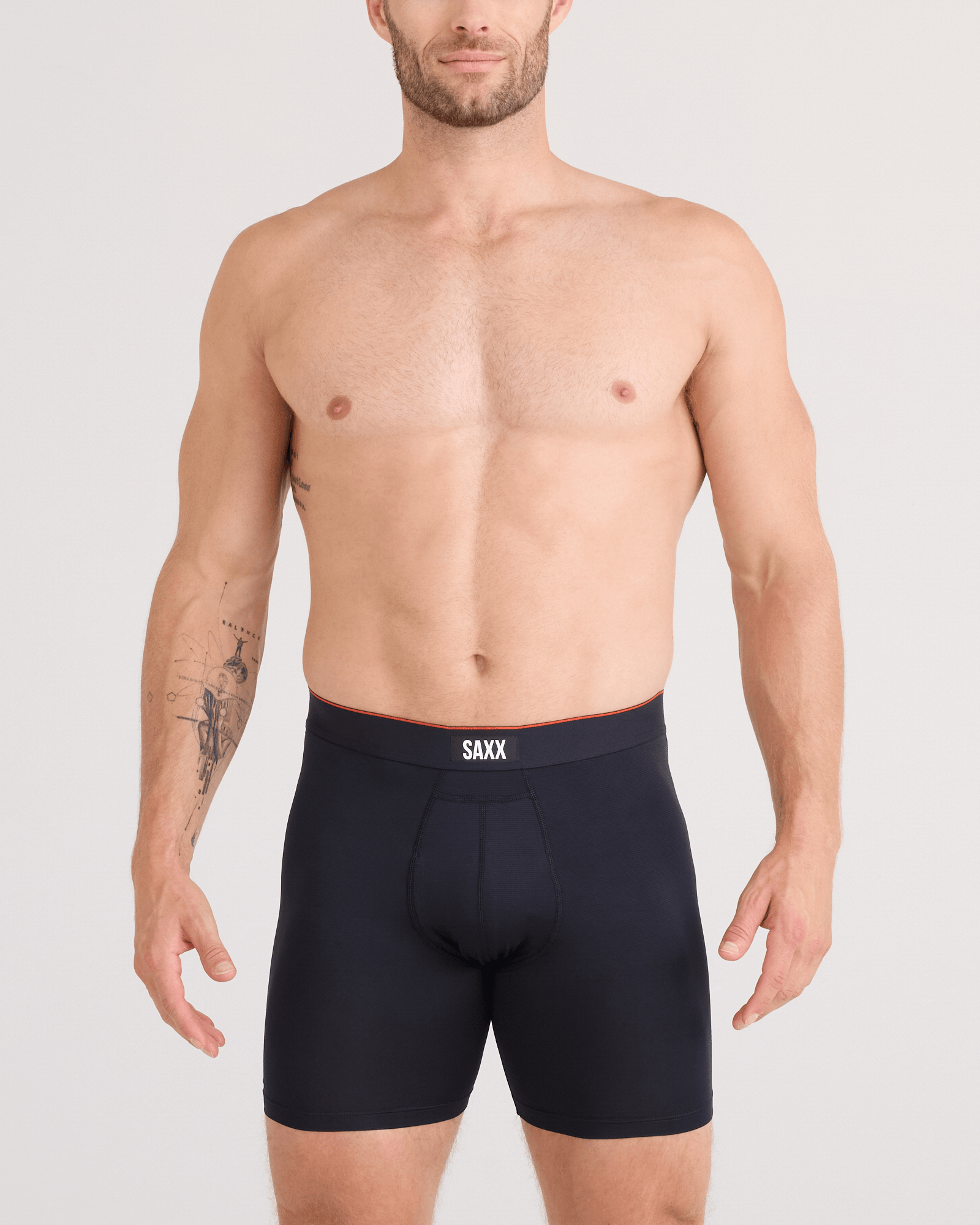 Man wearing black SAXX underwear on a plain background