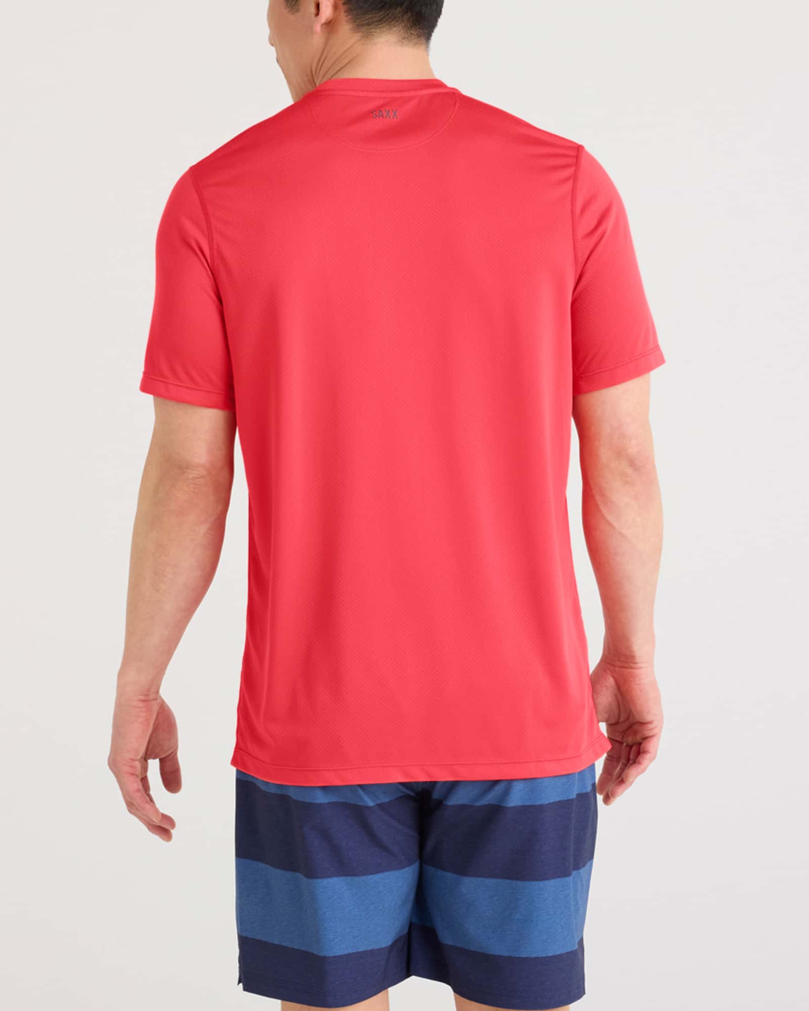 Back - Model wearing Multi-Sport Tech Tee in Coral Red