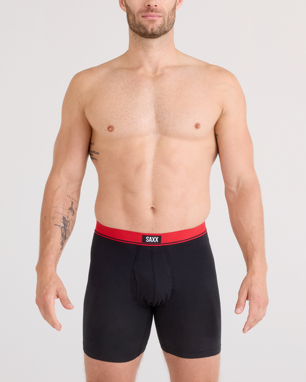 Front - Model posing in Essential Cotton Boxer Brief in Red/Navy/Turbulence Waistband